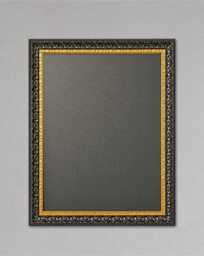 This 14x18 black and gold magnetic board features a textured magnetic steel surface inside an ornate solid wood frame displayed against a neutral gray wall background.