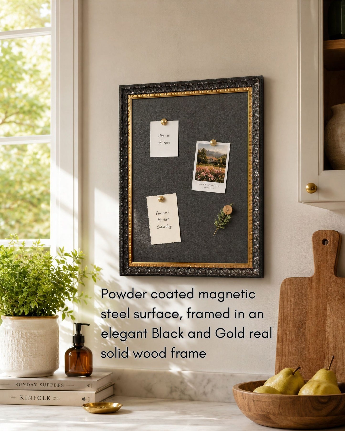 This 14x18 black and gold magnetic board features a powder coated magnetic steel surface and solid wood frame styled in a bright kitchen with notes, photos, and decorative magnets.