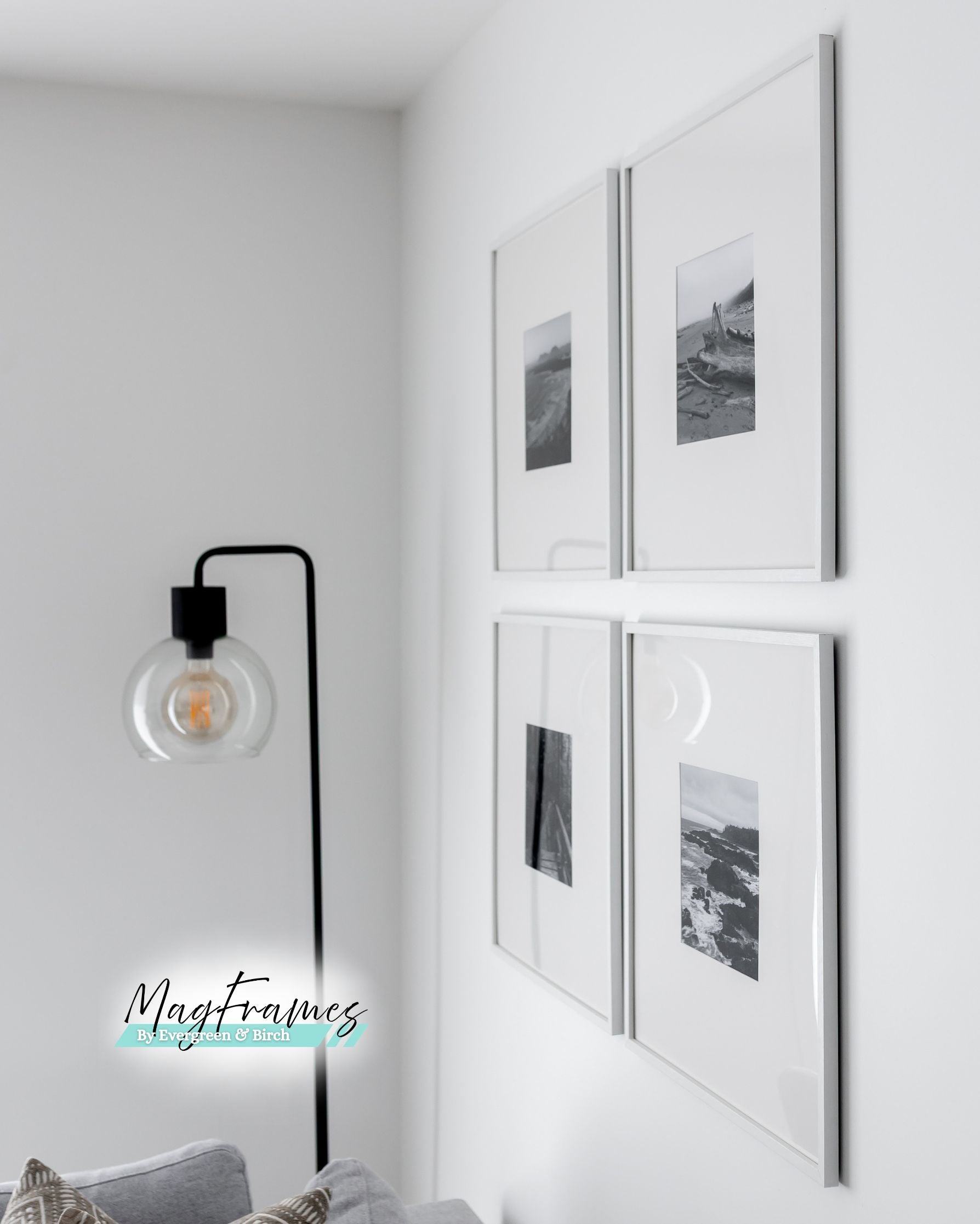 Four 20x20 white MagFrames with plexiglass displayed in a clean gallery wall layout beside a floor lamp.

