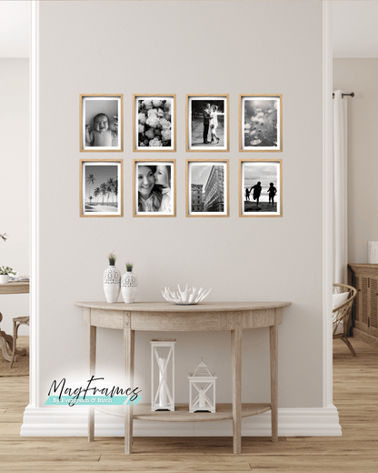 8x12 oak magnetic photo frames arranged as a gallery wall above a wooden console table in a modern Scandinavian home.