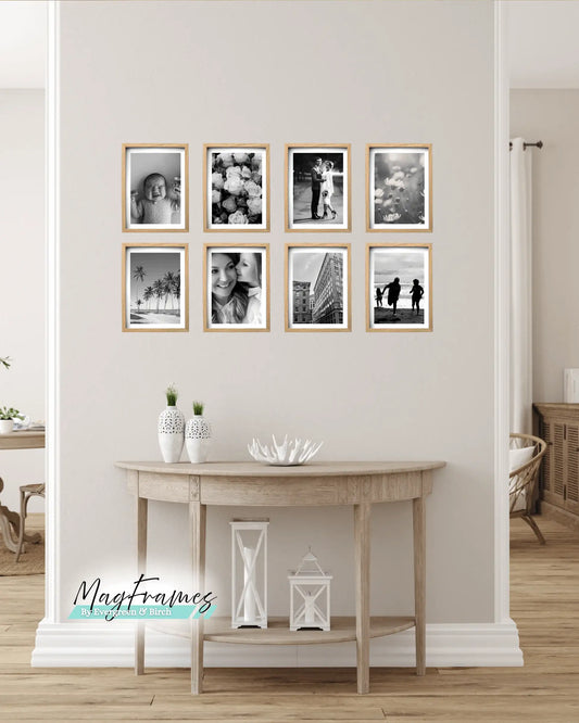 8x12 oak magnetic photo frames arranged as a gallery wall above a wooden console table in a modern Scandinavian home.
