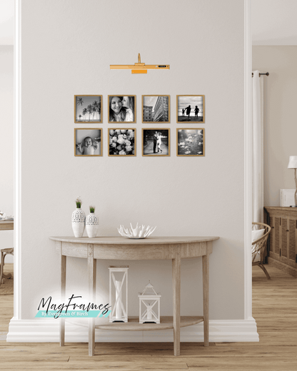 8x8 oak magnetic peel and stick photo frames arranged as a gallery wall above a wooden console table.