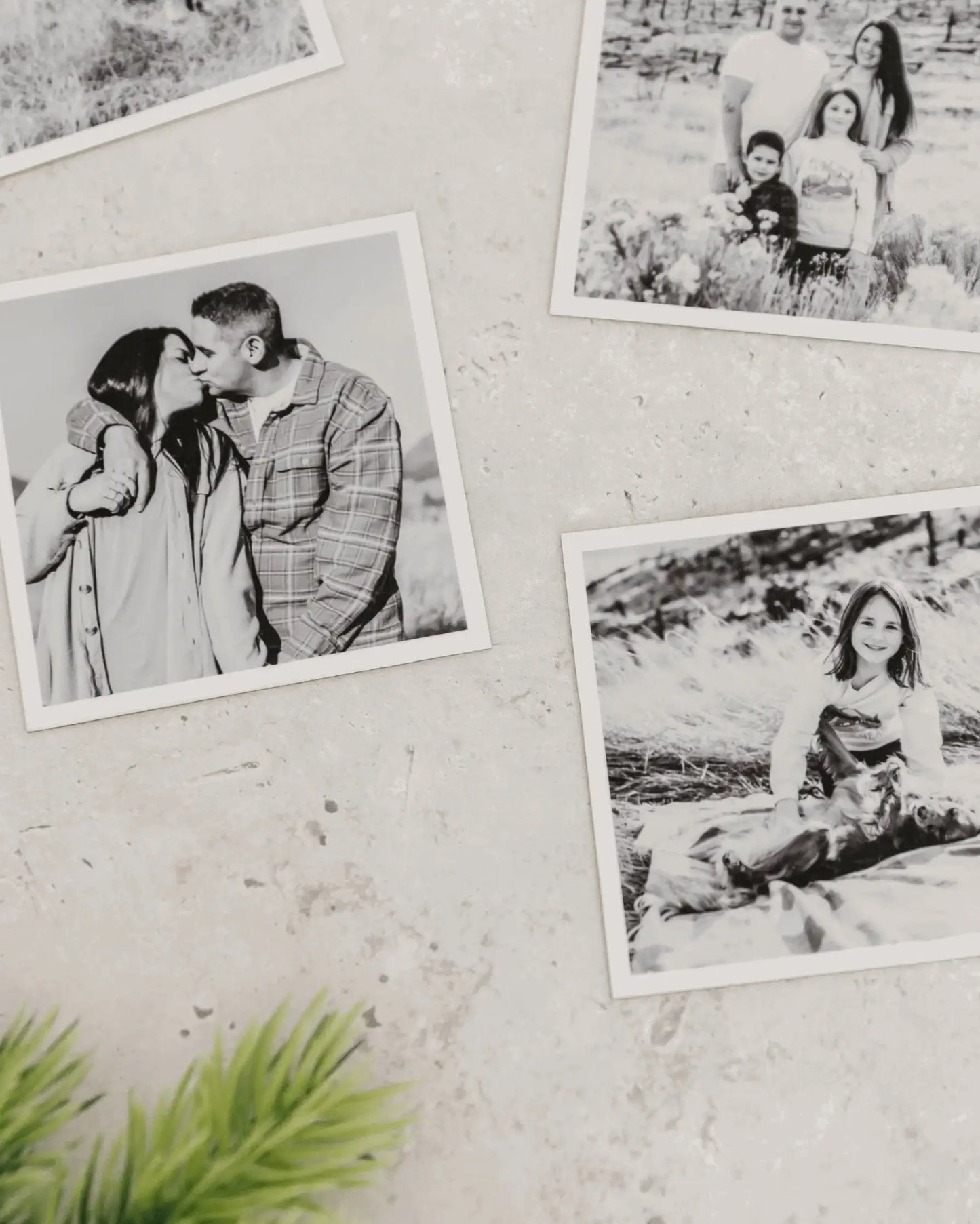 Close-up of black and white custom photo magnets with matte finish displayed on a light textured wall.