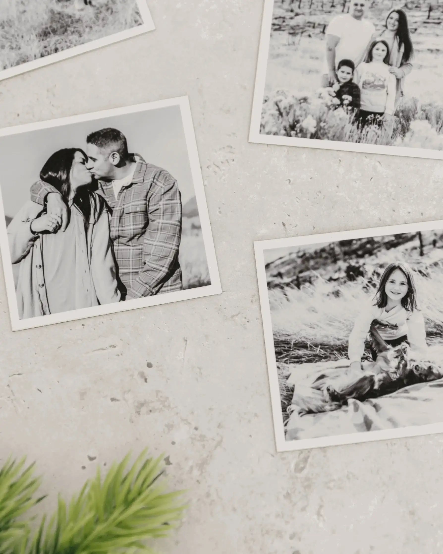 Close-up of black and white custom photo magnets with matte finish displayed on a light textured wall.