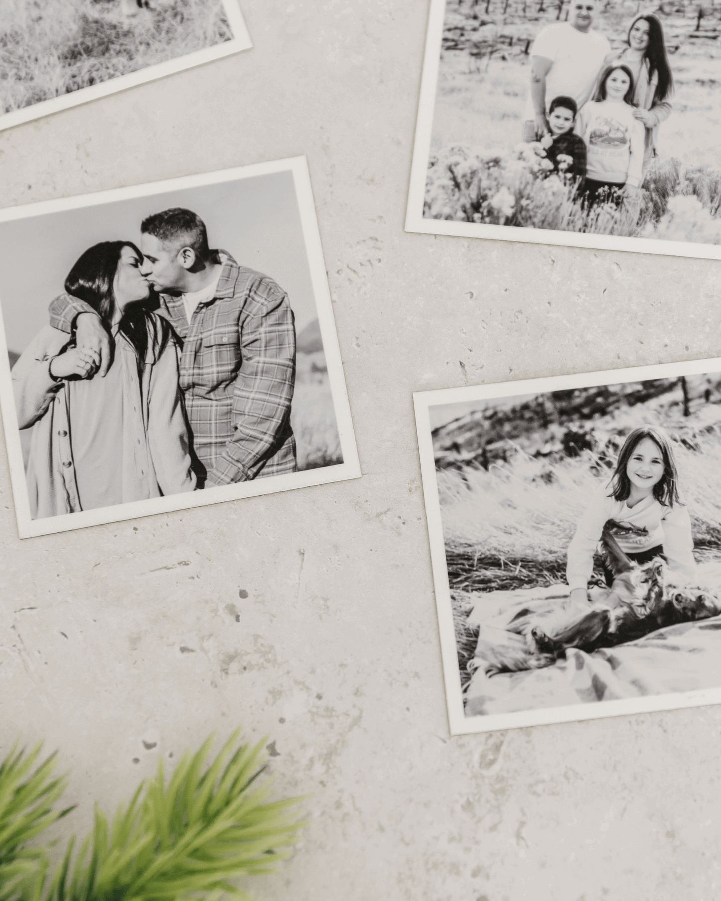 Close-up of black and white custom photo magnets with matte finish displayed on a light textured wall.