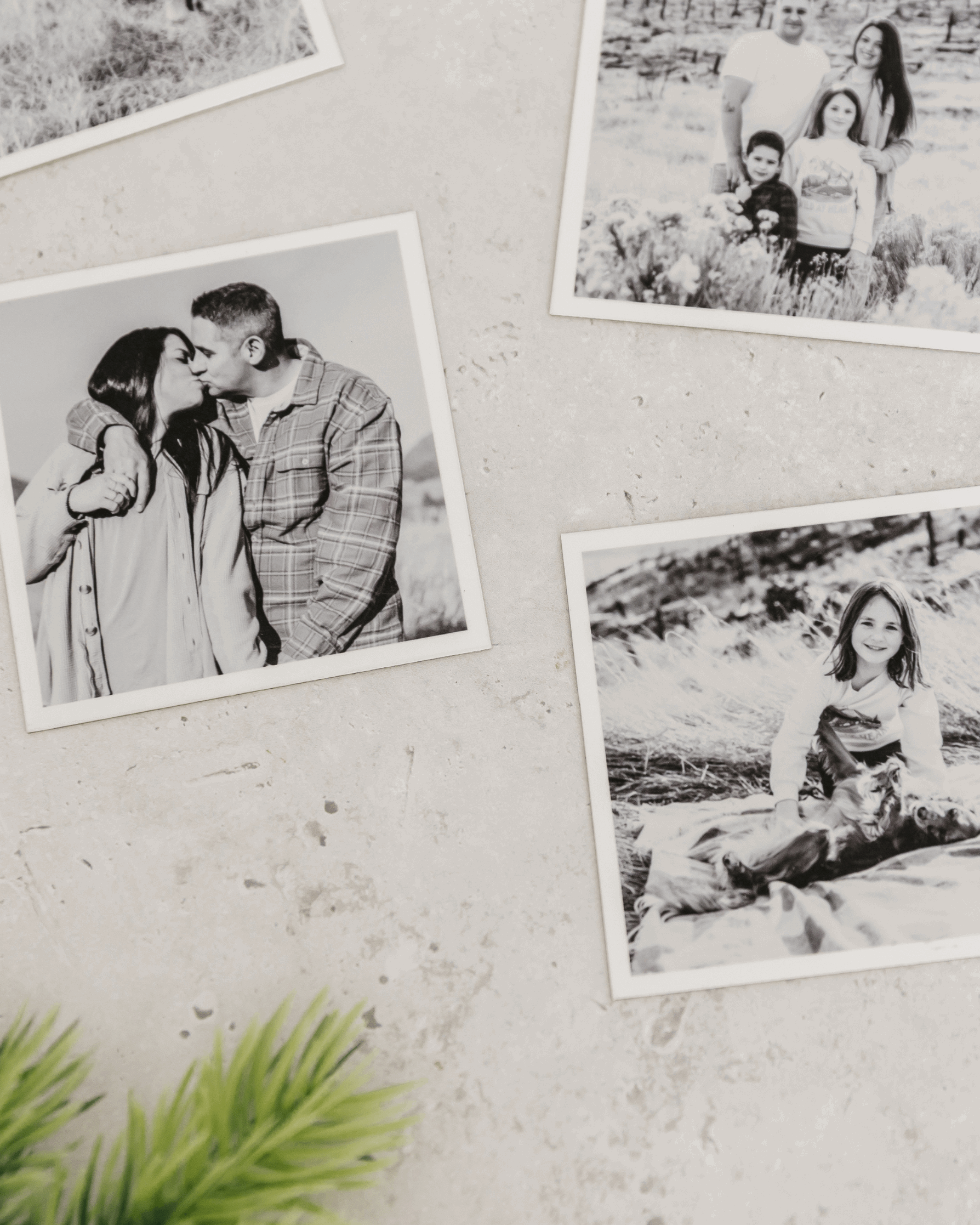 Close-up of black and white custom photo magnets with matte finish displayed on a light textured wall.