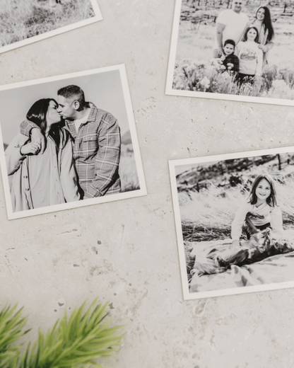 Close-up of black and white custom photo magnets with matte finish displayed on a light textured wall.