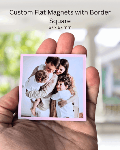 Custom square photo magnet with coloured border, 67x67mm size, held in hand to show scale.