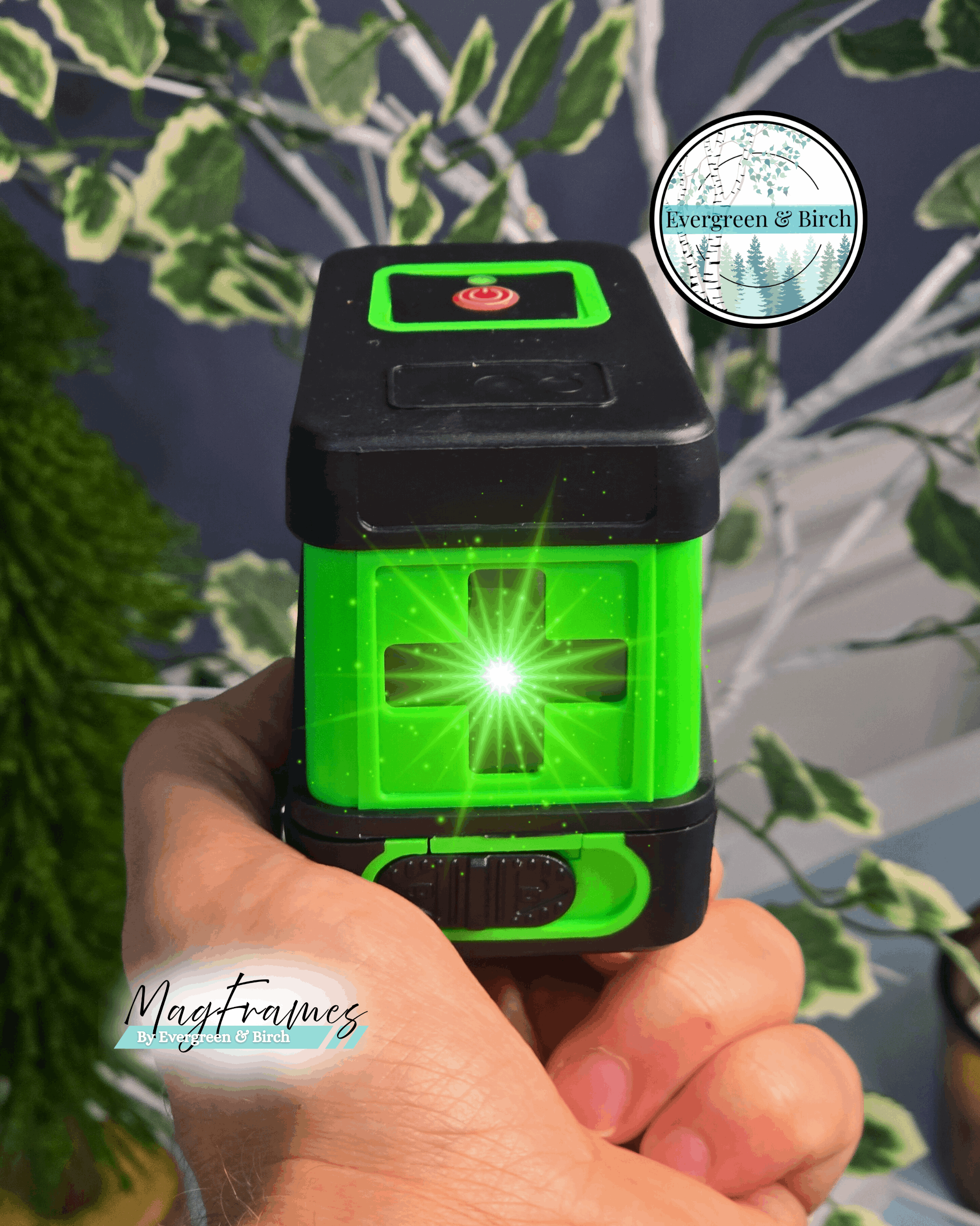 Green self-leveling laser level with cross line beams for hanging gallery wall frames, includes tripod and magnetic bracket by Evergreen & Birch.