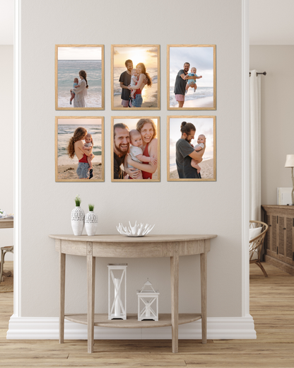 12x16 magnetic photo frames in natural oak arranged as a modern gallery wall with family photos above a wooden console table in a bright Scandinavian-style home