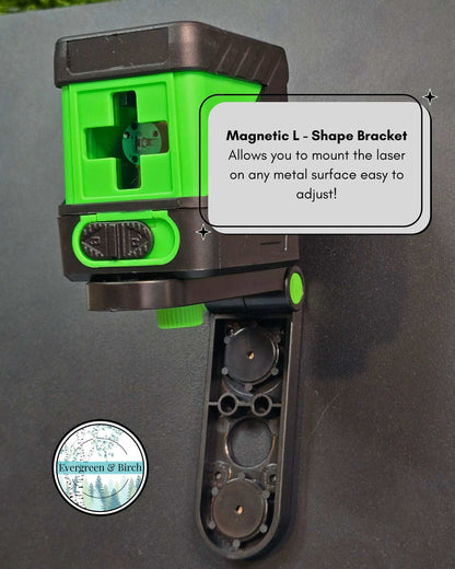 Green self-leveling laser level mounted on magnetic L-shape bracket attached to metal surface for easy gallery wall alignment.