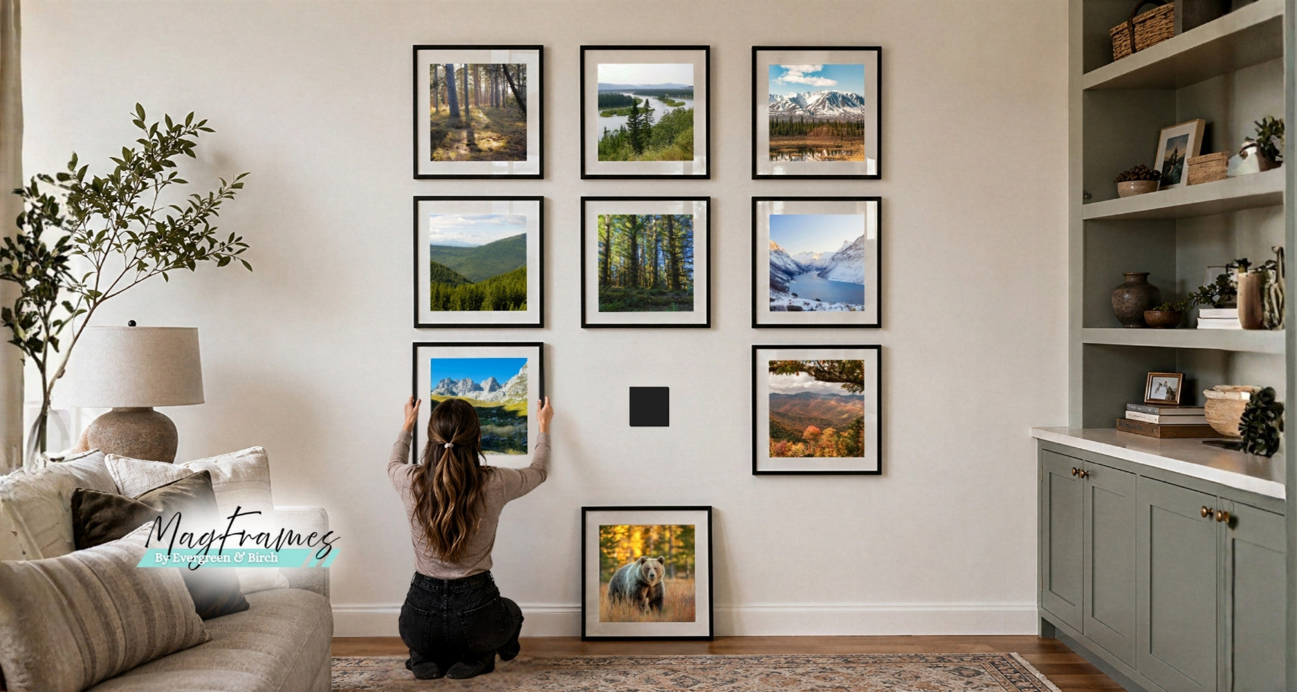 woman arranging magnetic photo frames in a gallery wall layout with landscape prints in a modern living room