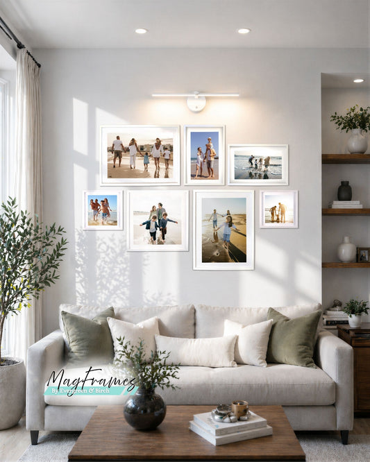 Meadow wireless picture light above gallery wall of white photo frames in modern living room decor