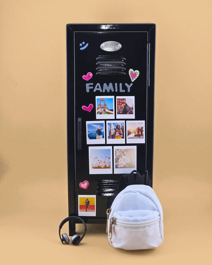 Black mini retro metal locker decorated with family photo magnets, styled as a desk organizer with mini backpack and headphones.
