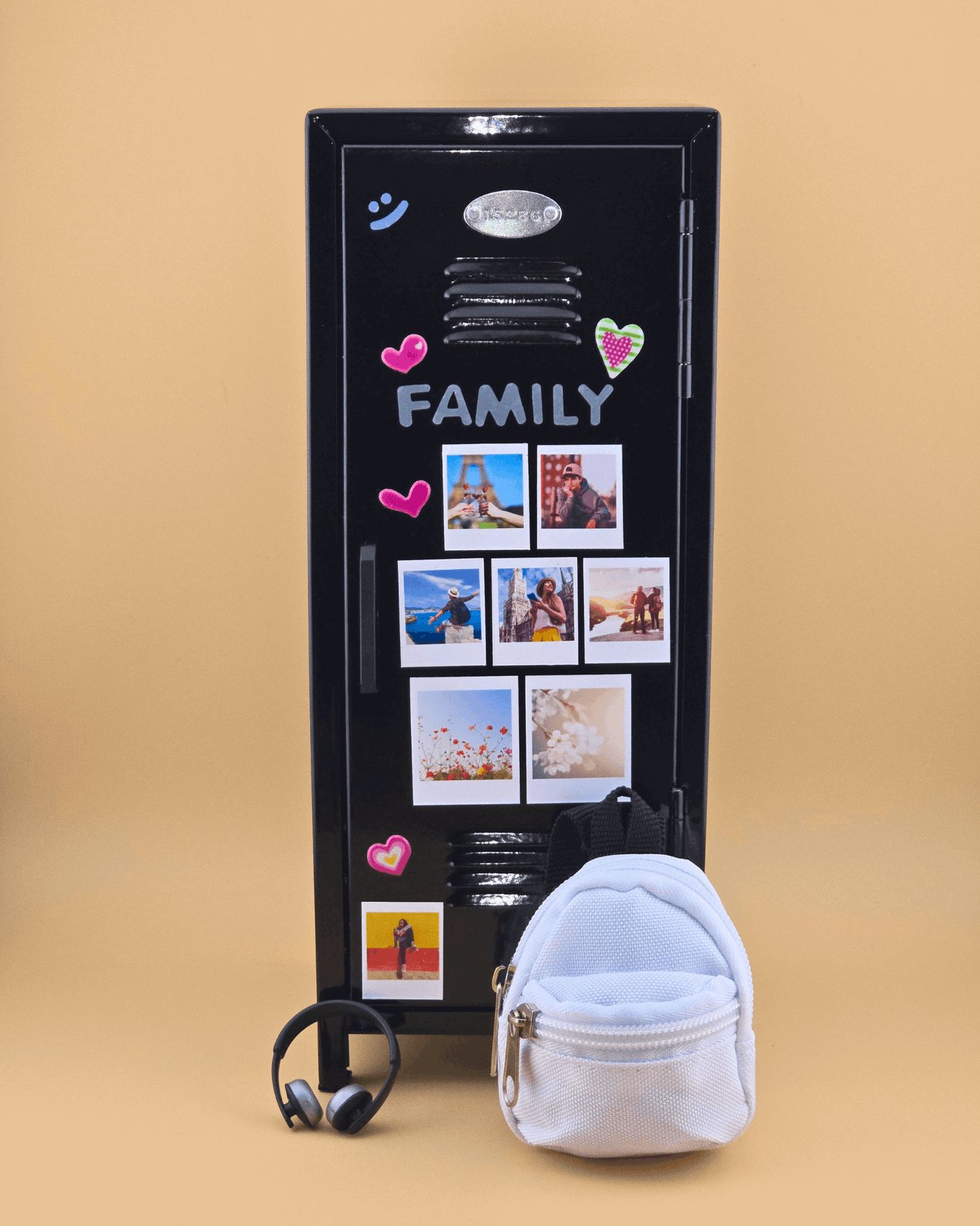 Black mini retro metal locker decorated with family photo magnets, styled as a desk organizer with mini backpack and headphones.