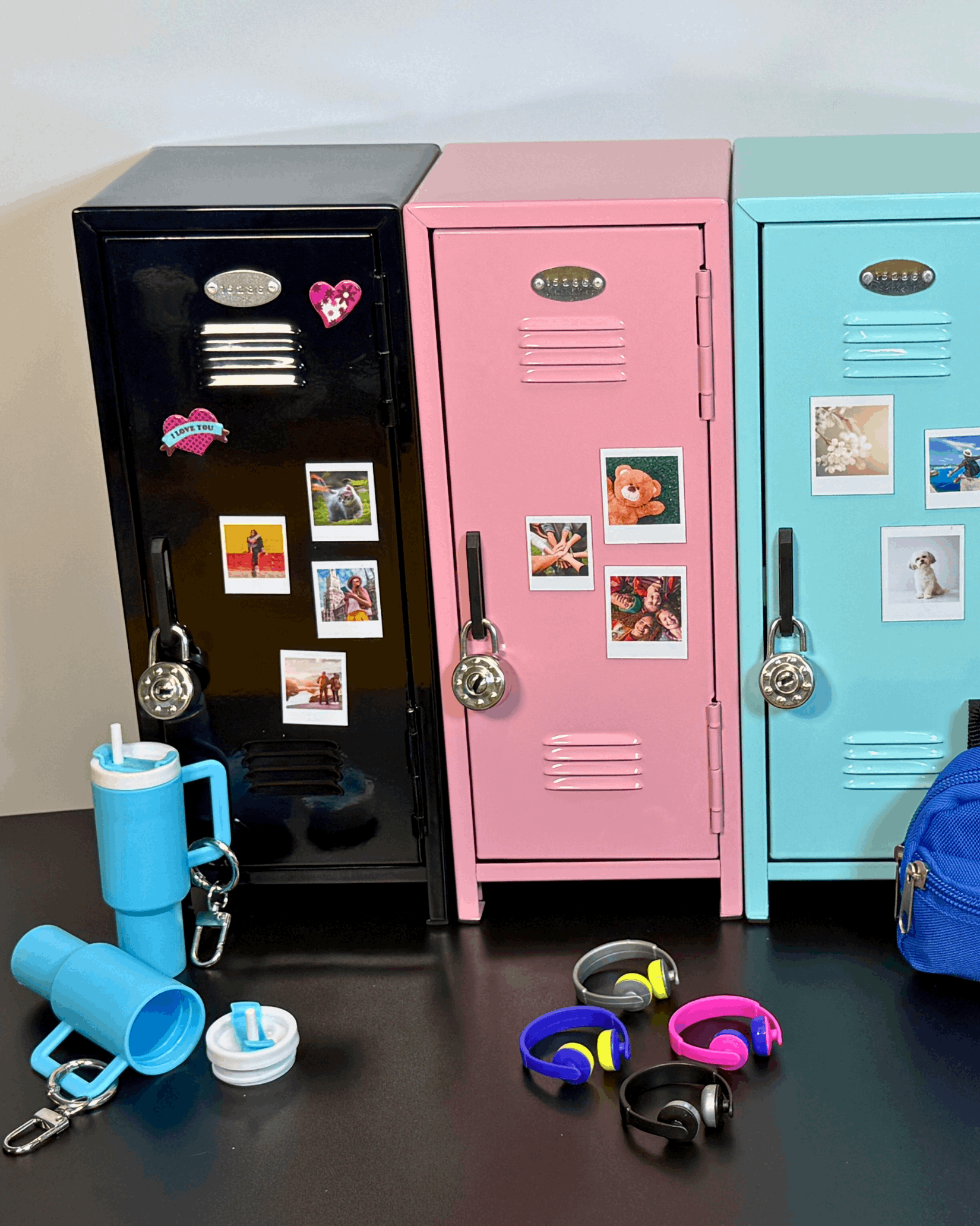 Mini retro metal lockers in black, pink, and blue with magnetic photo prints displayed on doors.
