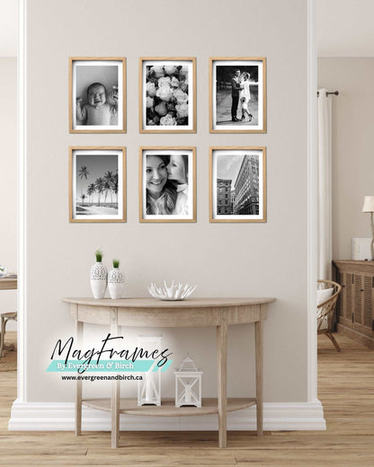 Six oak MagFrames magnetic photo frames arranged as a black and white gallery wall above a console table
