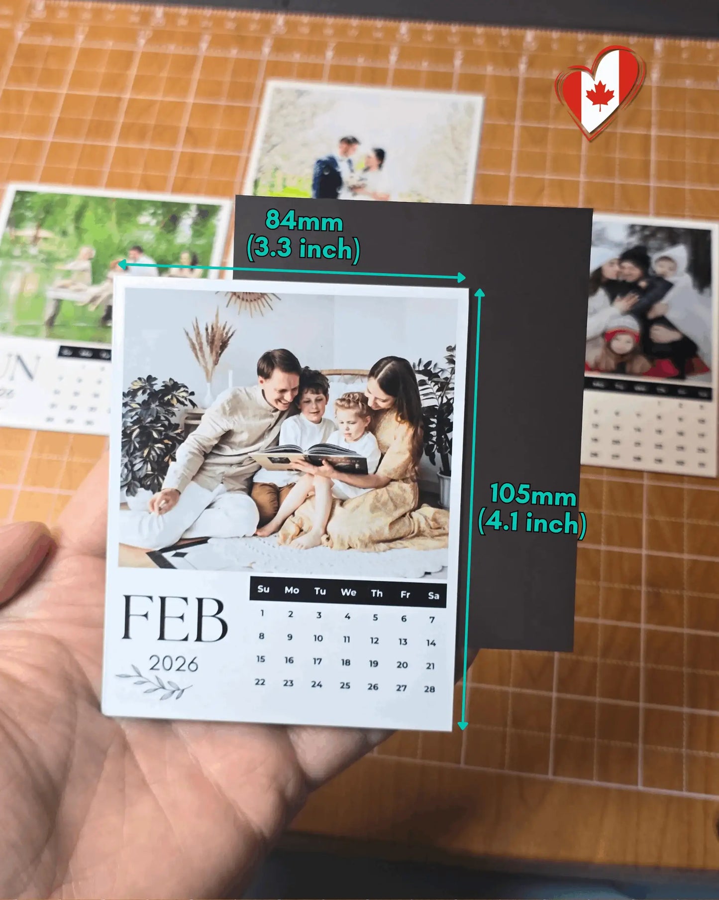 Hand holding 2026 personalized magnetic photo calendar showing 84mm x 105mm size.